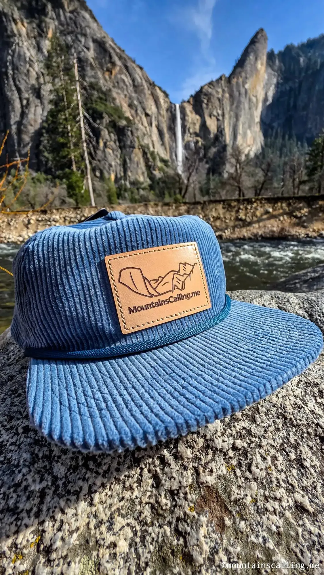 The corduroy trucker hat on a granite ledge below Yosemite Falls